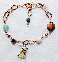 PugSpeak Pug Bracelet 13 - This light and delicate pug bracelet features a gold-plated chain in a rose shade. We've added a creamy Limestone, green Aventurine, eggplant purple Raku, Malachite, a copper lentil, and fawn enamel pug charm. Adjusts from 6.75" to 8.50" (17.145 to 21.59 cm).