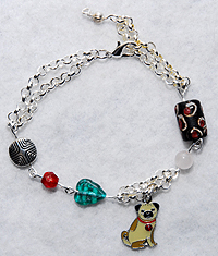 PugSpeak Pug Bracelet 6 -Small looped Silver plated chain is doubled and features African wood, Czech glass and silver pewter Bali bead with fawn enamel pug charm. Adjusts from 7.00" to 8.00" (17.78 - 20.32 cm).