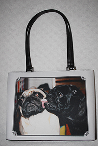 This is a custom made pug handbag featuring PugSpeak's own Dexter and Trevor. This pug bag features two interior pockets and a zipped closure with shoulder straps. Measures 13.00" X 9.5" X 3.00" (33.02 X 24.13 X 7.62 cm)
